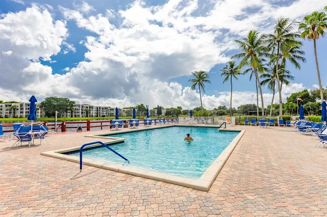 a view of a swimming pool with a lounge chairs