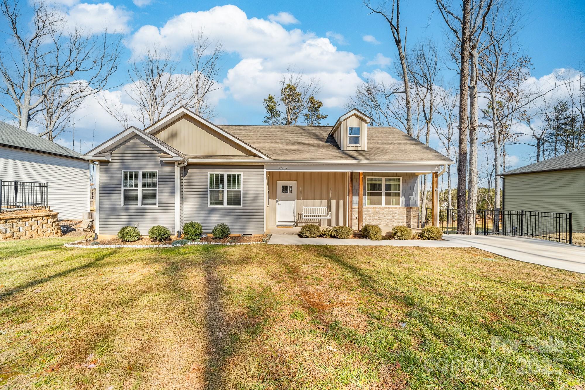 a front view of a house with a yard and outdoor seating