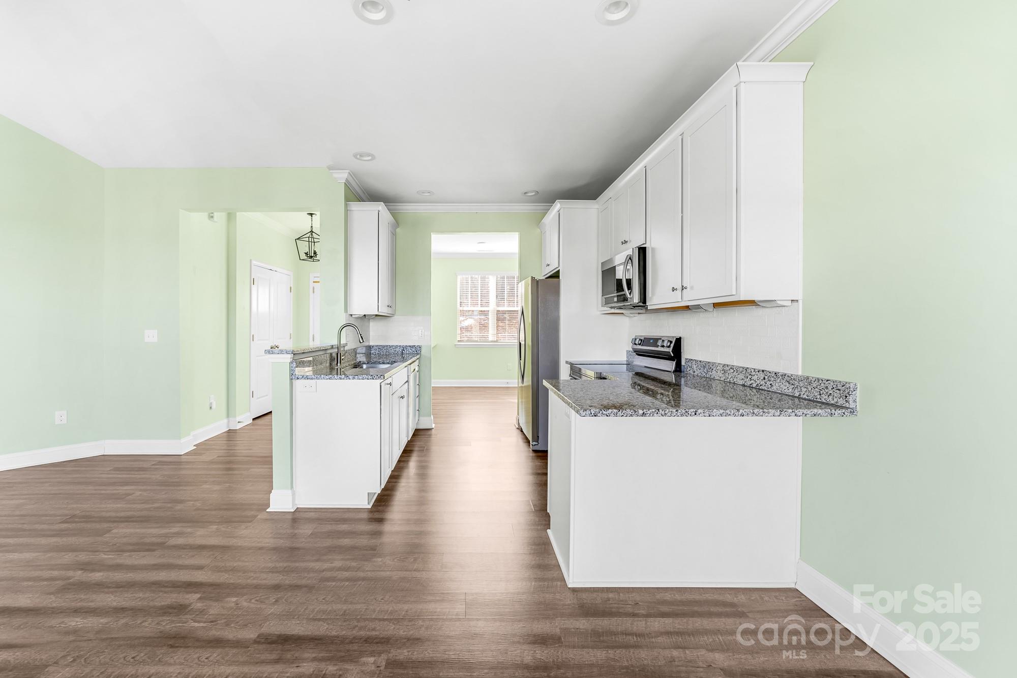 7617 Red Robin Trail Denver, NC 28037 - Photo 11 of 38 a kitchen with stainless steel appliances granite countertop a sink stove and refrigerator