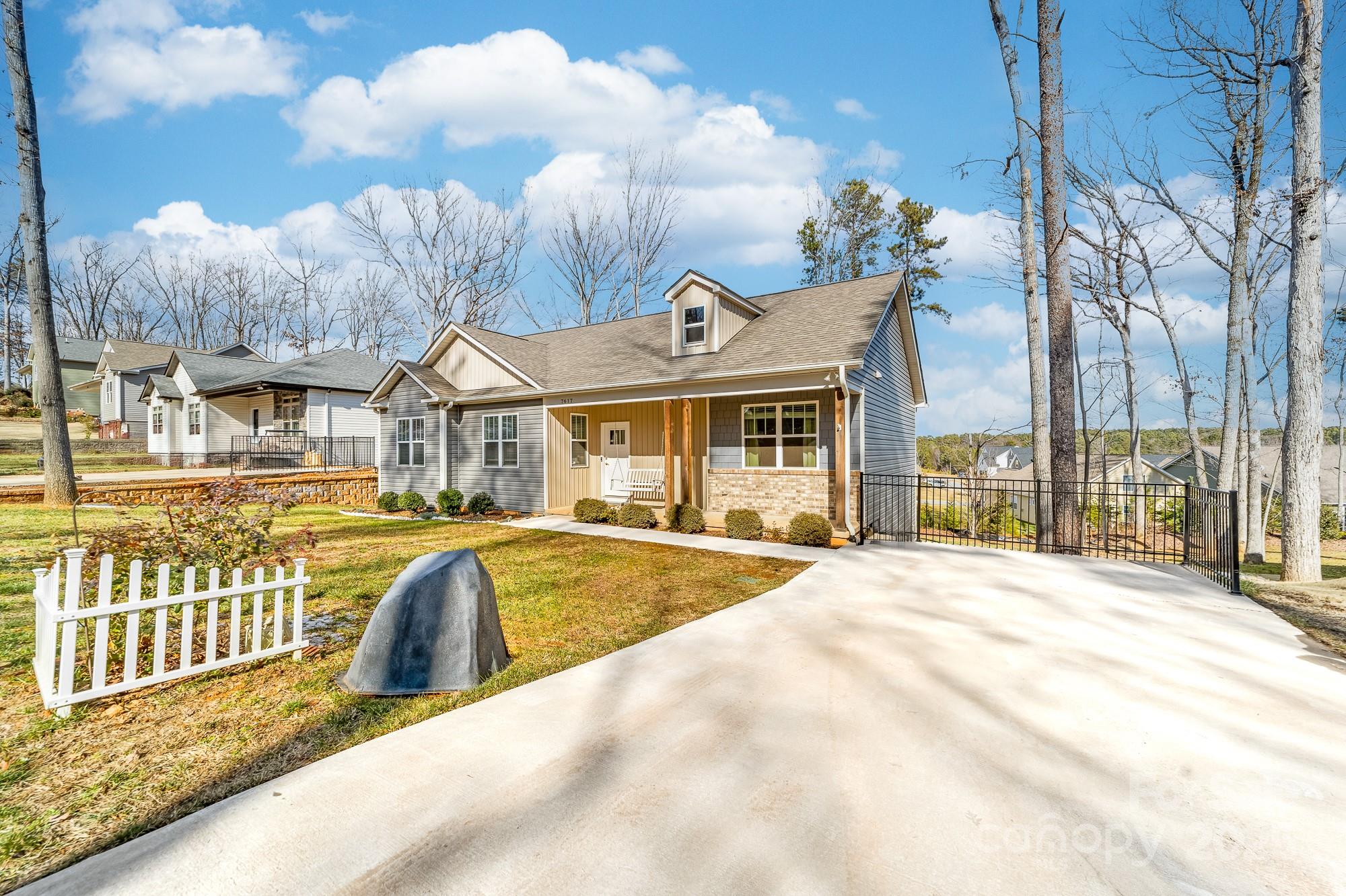 7617 Red Robin Trail Denver, NC 28037 - Photo 3 of 38 a view of a house with a swimming pool and sitting area
