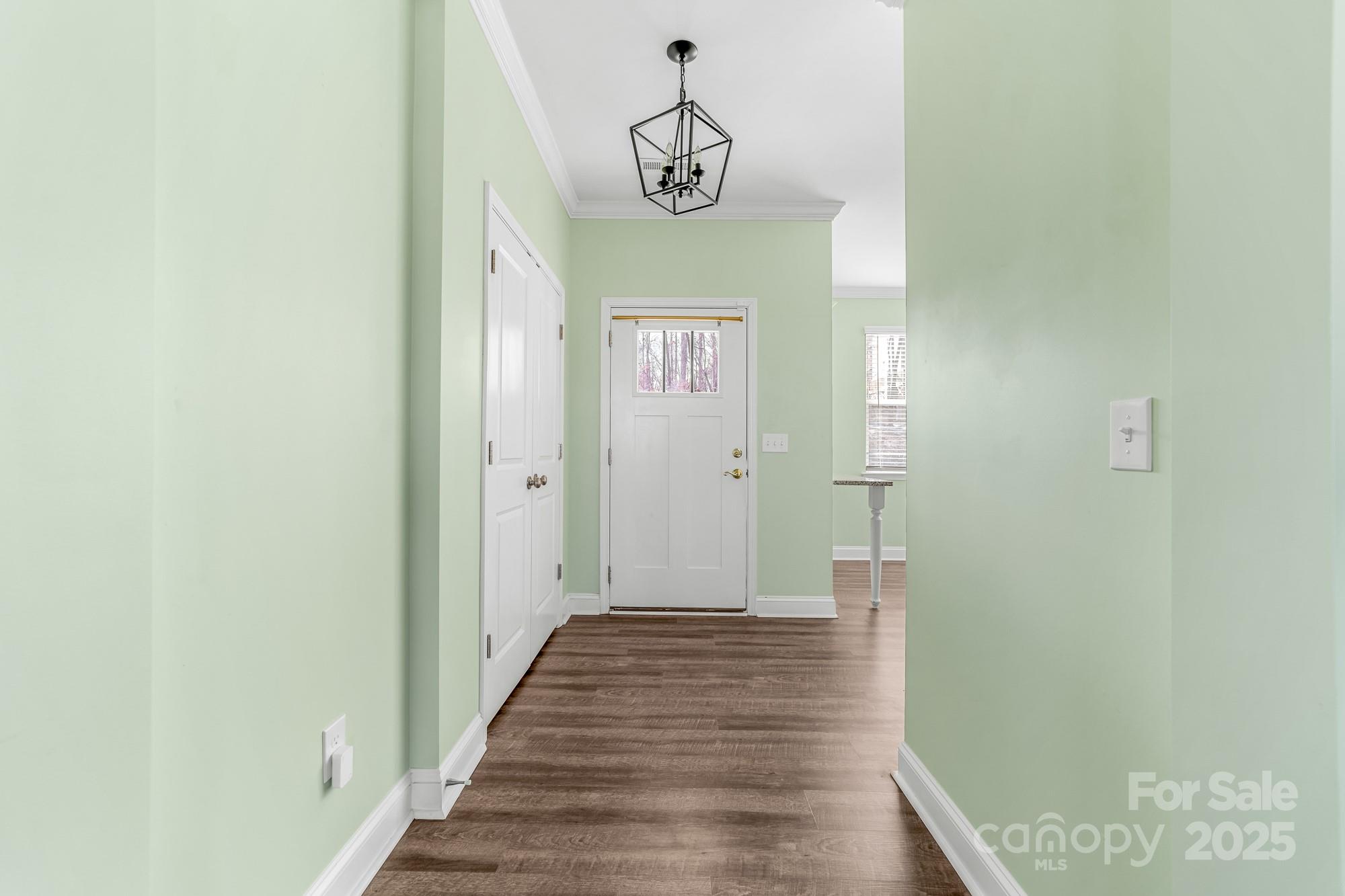 7617 Red Robin Trail Denver, NC 28037 - Photo 4 of 38 a view of a hallway with wooden floor and staircase
