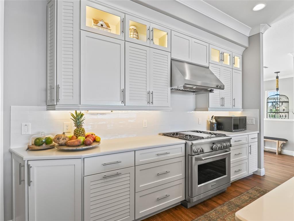 12943 Southeast Sunset Harbor Road Weirsdale, FL 32195 - Photo 21 of 87 a kitchen with stainless steel appliances white cabinets and a stove top oven