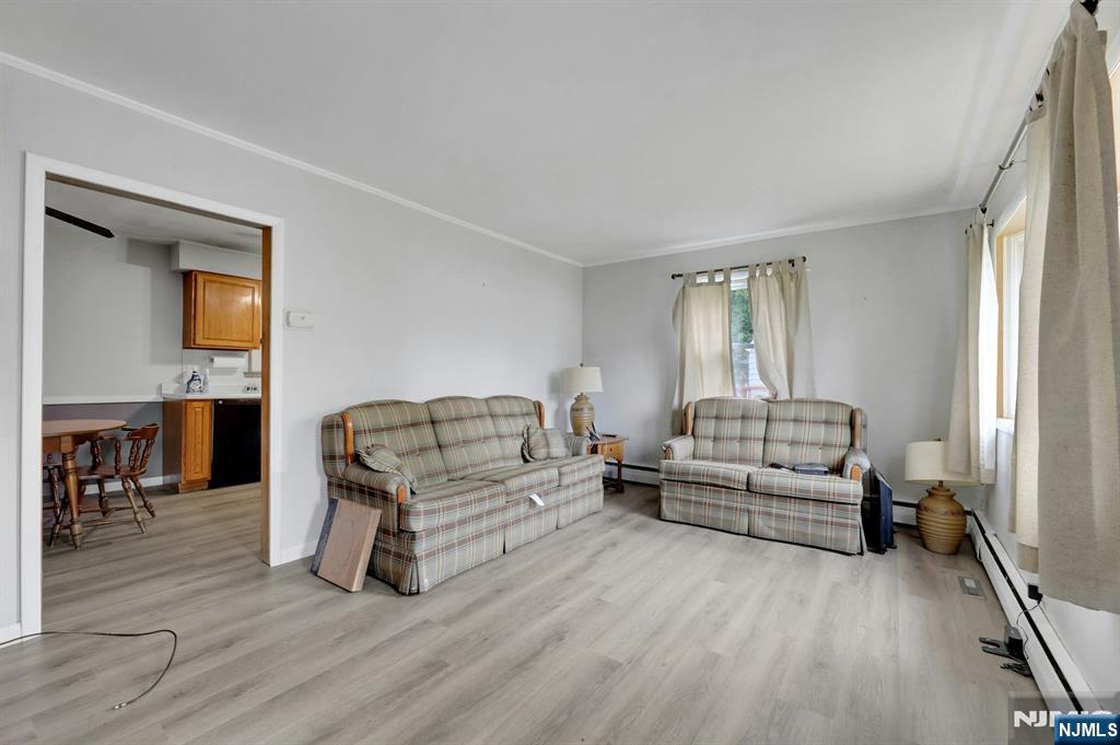 17 Butler Place Wanaque, NJ 07420 - Photo 20 of 28 a living room with furniture and a wooden floor
