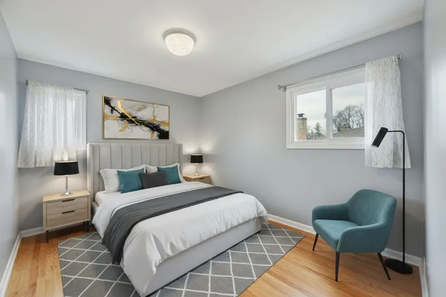 a bedroom with a bed and a painting on the wall