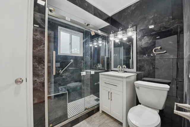 a bathroom with a toilet sink and shower