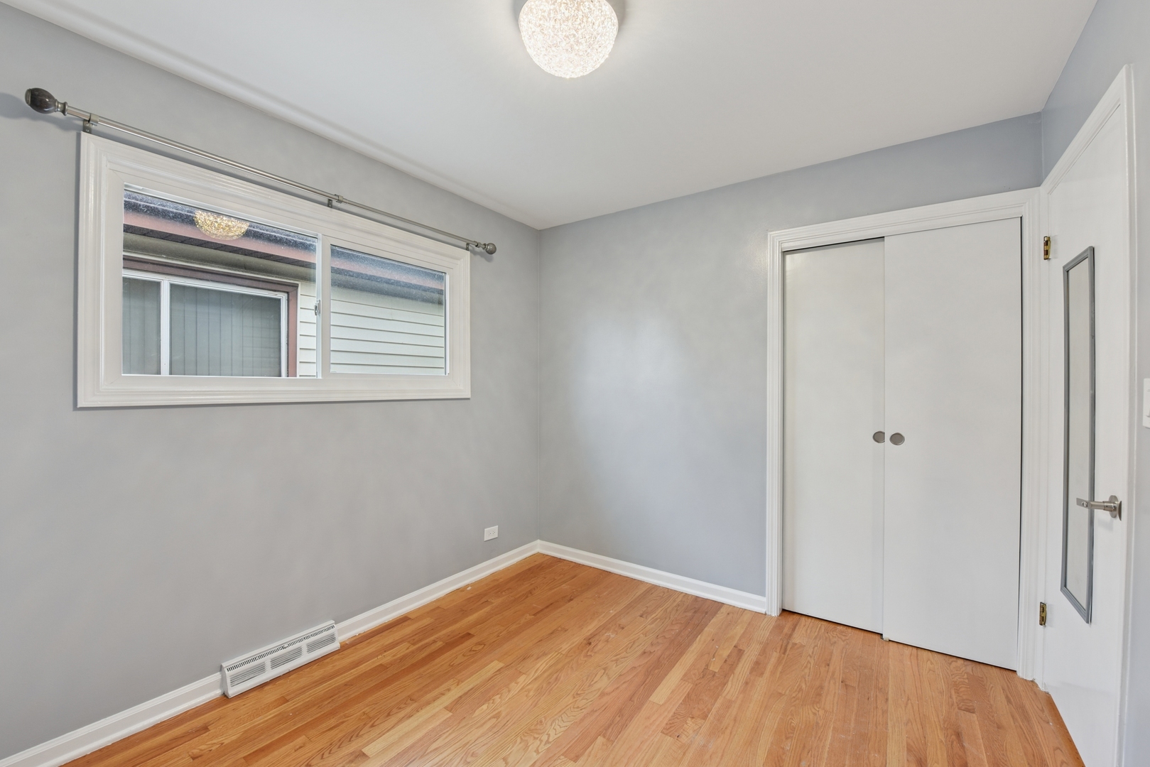 5829 Madison Street Morton Grove, IL 60053 - Photo 15 of 28 a view of empty room with wooden floor and fan