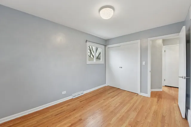 an empty room with wooden floor