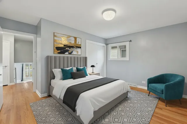 a bedroom with a bed a lamp and a rug