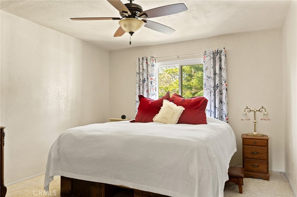 337 Lookout Drive Twin Peaks, CA 92391 - Photo 15 of 32 a bedroom with a bed and a chandelier