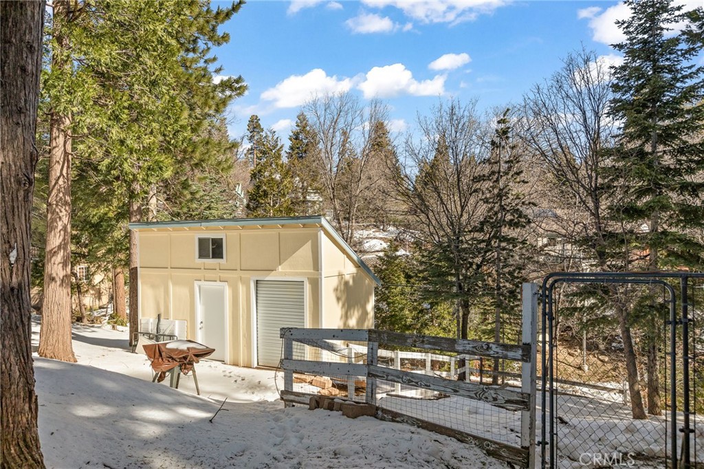 337 Lookout Drive Twin Peaks, CA 92391 - Photo 28 of 32 a view of a white house with a large tree and lawn chairs
