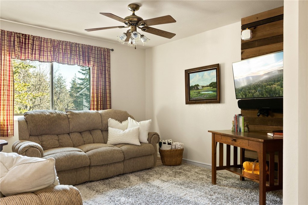 337 Lookout Drive Twin Peaks, CA 92391 - Photo 10 of 32 a living room with furniture a flat screen tv and a large window