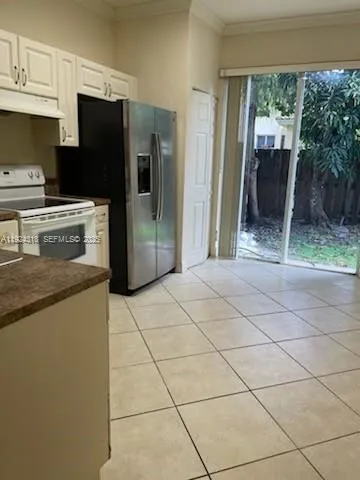 a kitchen with stainless steel appliances a refrigerator and a stove