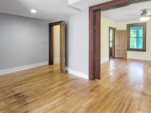 a view of a hallway with wooden floor and entryway