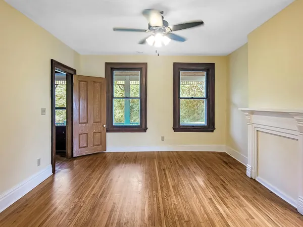 a view of a kitchen with wooden floor and cabinets