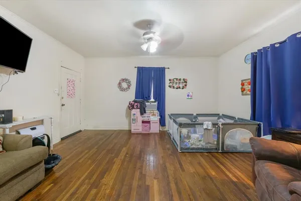 a living room with furniture and a flat screen tv