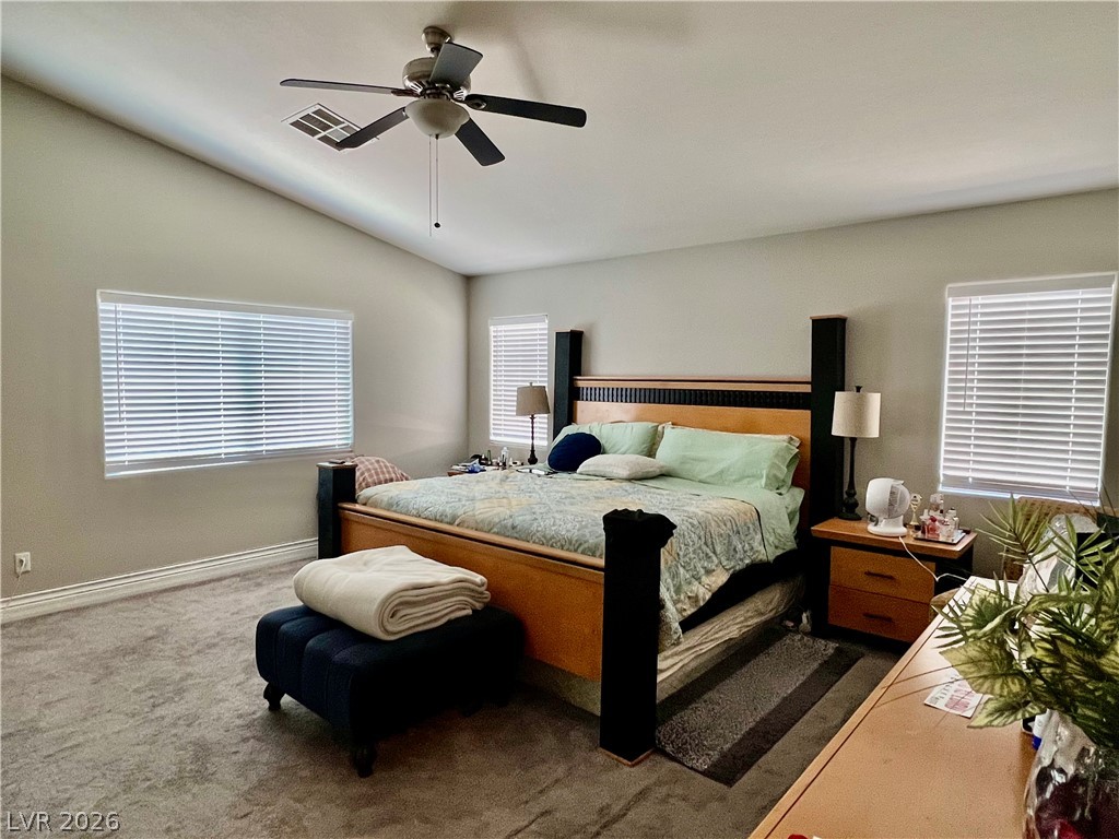 151 Short Ruff Way Las Vegas, NV 89148 - Photo 3 of 17 Plentiful natural light fills a tranquil sleeping space featuring vaulted ceilings and plush carpeting. Large Walk in Closet, with En suite Bathroom Double vanity. Bedroom Separated from others.