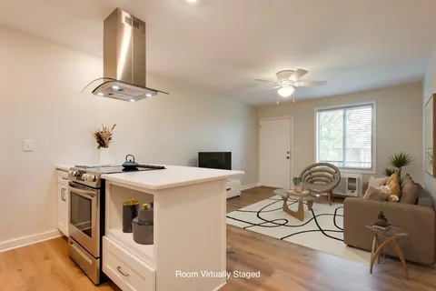 a view of a livingroom with furniture and a window