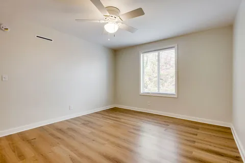 wooden floor in an empty room with a window