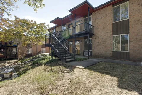 a view of a house with wooden fence