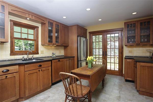 49 Thurston Road Newton, MA 02464 - Photo 3 of 5 a kitchen with kitchen island granite countertop a sink and wooden cabinets