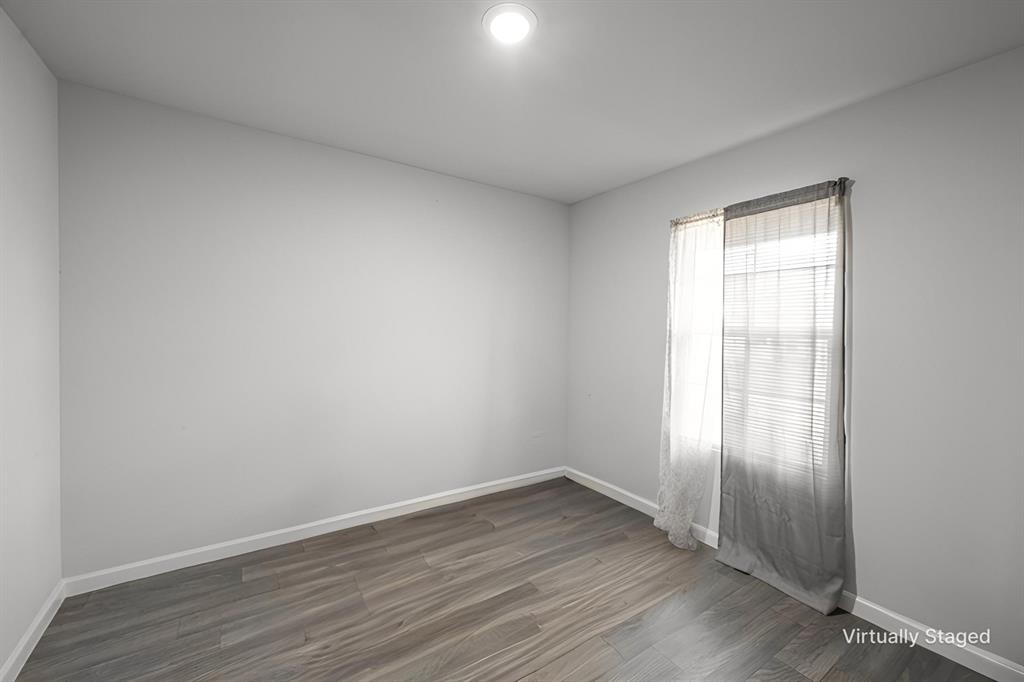 1106 Ripplewood Circle Chandler, TX 75758 - Photo 12 of 24 a view of an empty room with wooden floor and a window