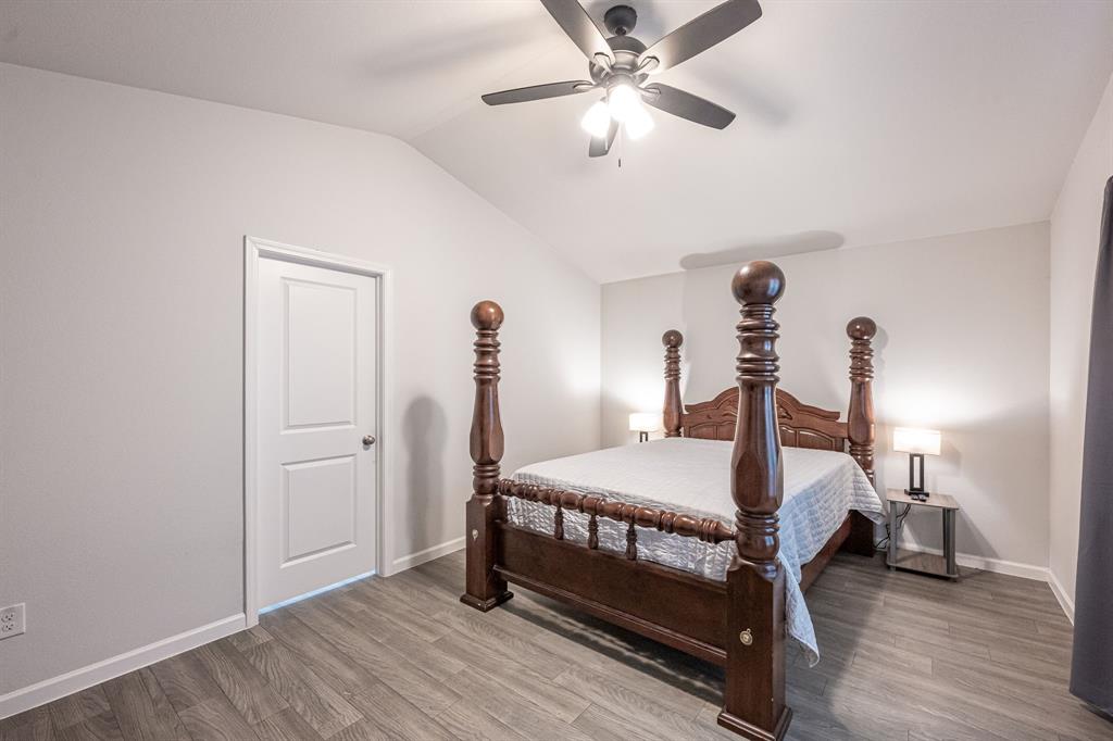 1106 Ripplewood Circle Chandler, TX 75758 - Photo 19 of 24 a bedroom with a bed and a chandelier