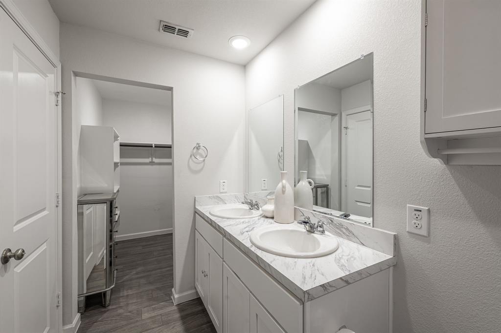 1106 Ripplewood Circle Chandler, TX 75758 - Photo 22 of 24 a bathroom with a granite countertop sink and a mirror