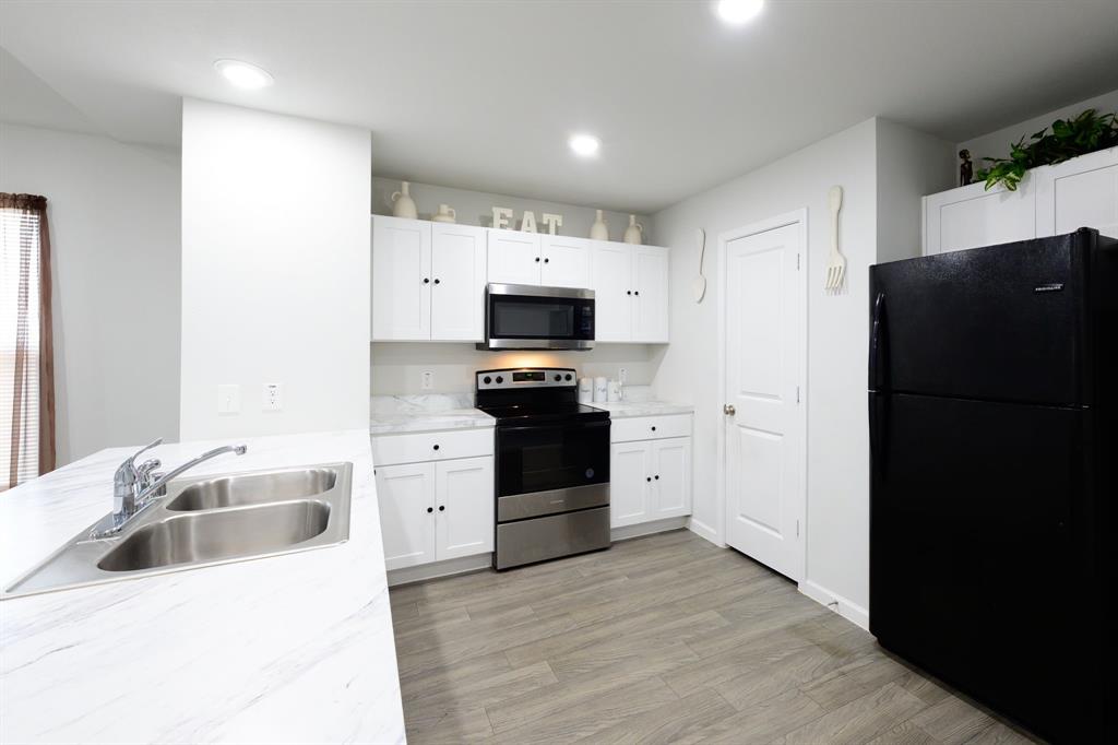 1106 Ripplewood Circle Chandler, TX 75758 - Photo 3 of 24 a kitchen with a refrigerator and a sink