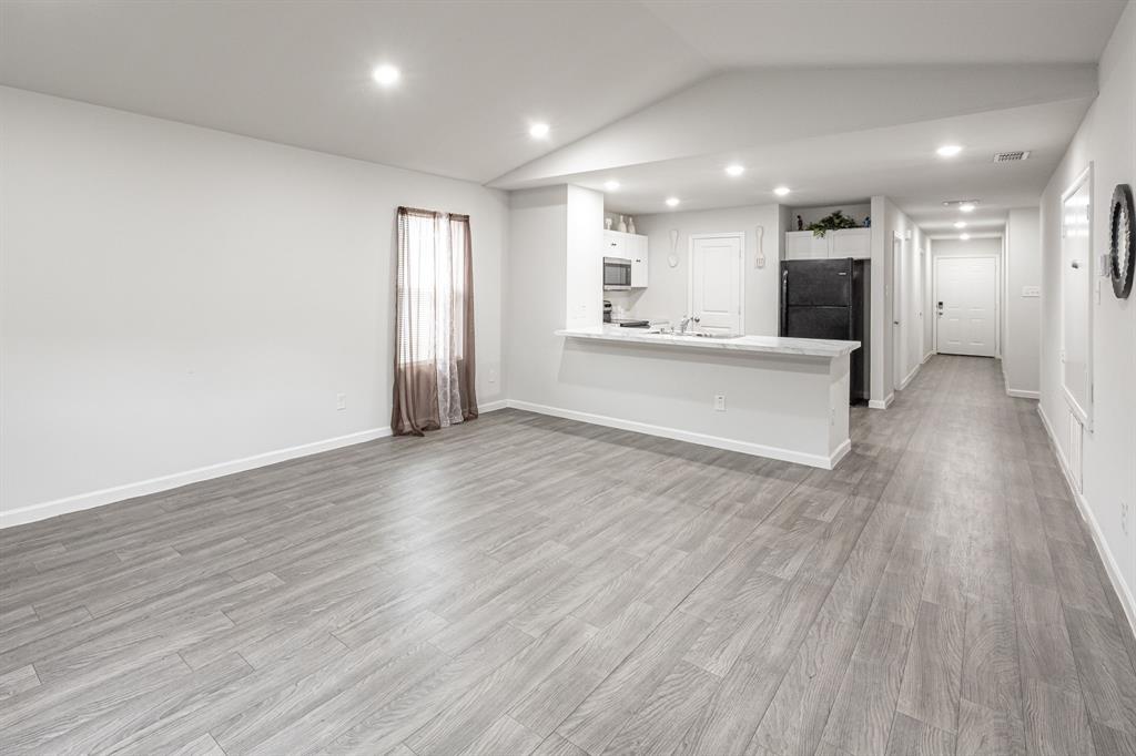 1106 Ripplewood Circle Chandler, TX 75758 - Photo 8 of 24 a view of kitchen with kitchen island wooden floor center island and stainless steel appliances