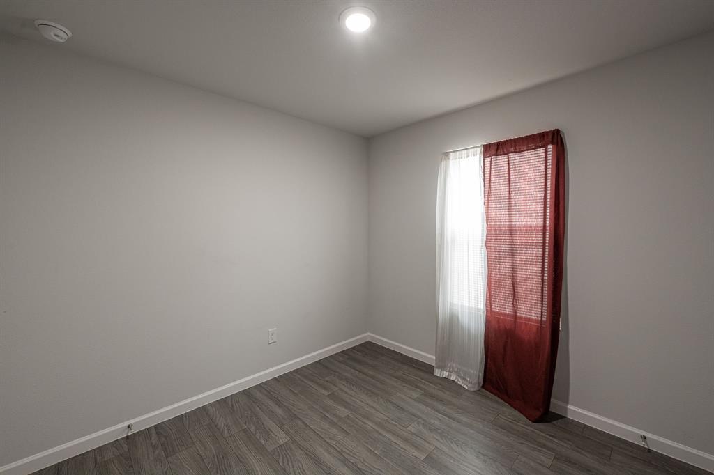 1106 Ripplewood Circle Chandler, TX 75758 - Photo 10 of 24 an empty room with wooden floor and windows