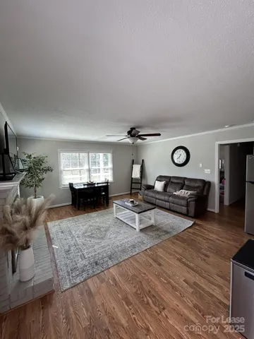 a living room with furniture and a wooden floor