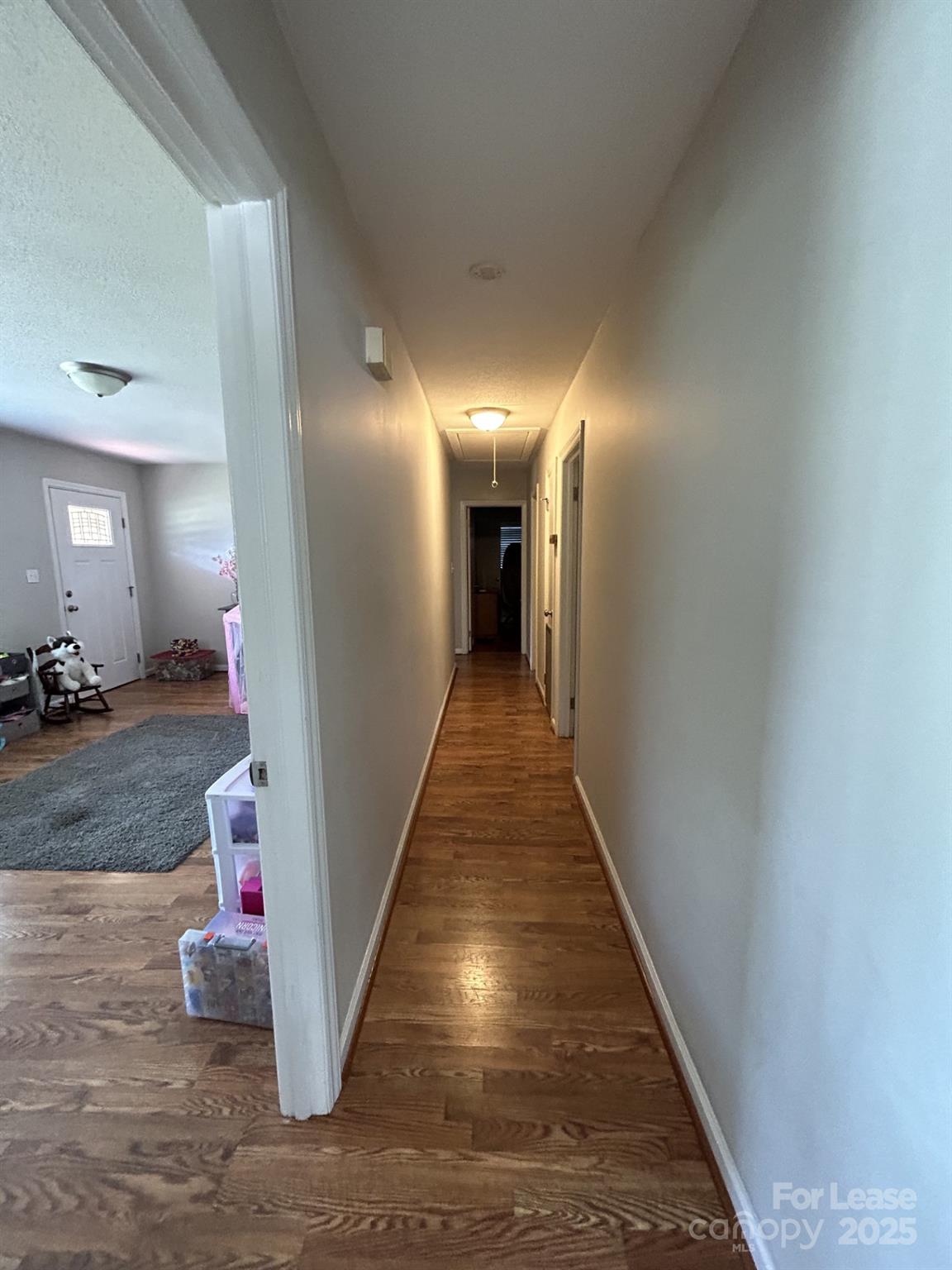6317 Morehead Road Harrisburg, NC 28075 - Photo 4 of 10 a view of a hallway with wooden floor