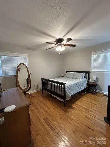 a bedroom with bed and a chandelier