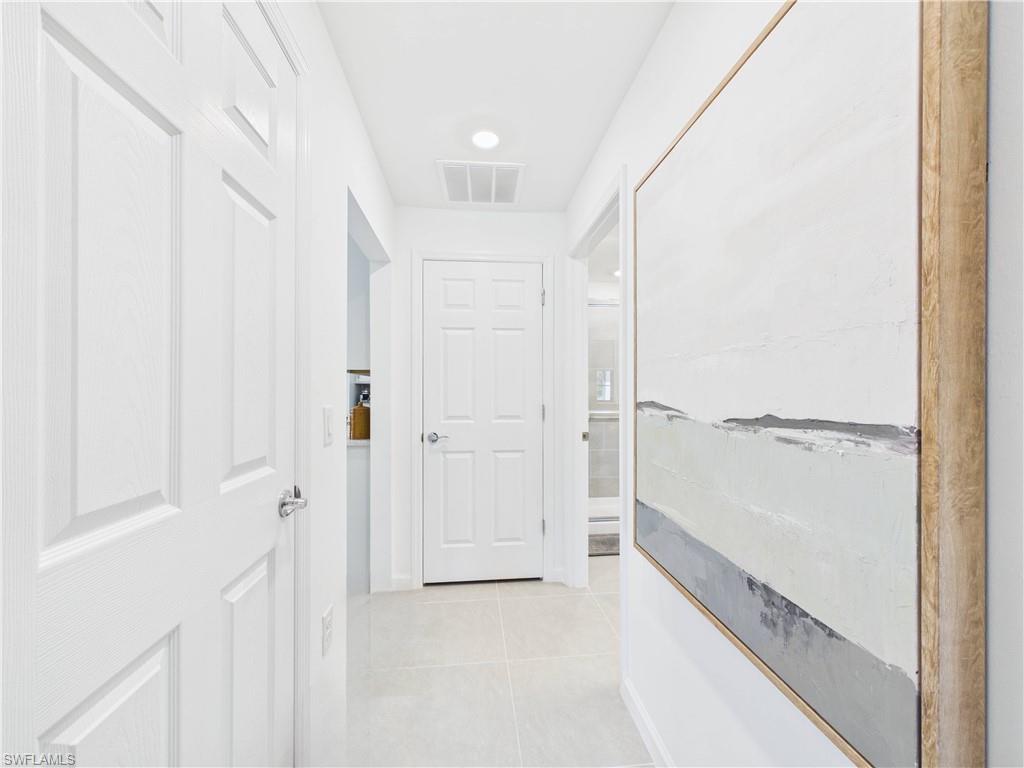 5683 Mayflower Way, Unit 908 Ave Maria, FL 34142 - Photo 14 of 37 Corridor with light tile patterned floors and recessed lighting