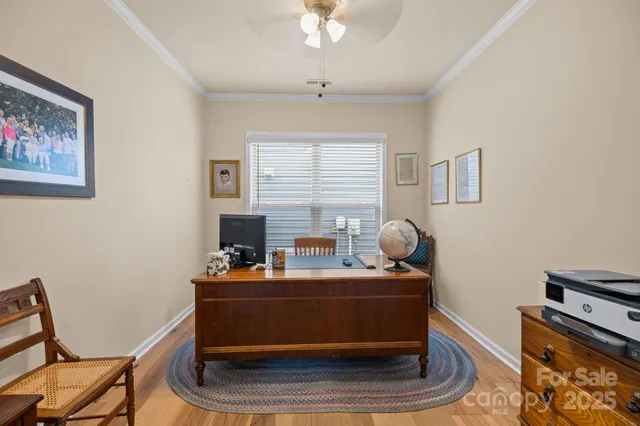 a kitchen with stainless steel appliances granite countertop a kitchen island a stove a sink a dining table and chairs