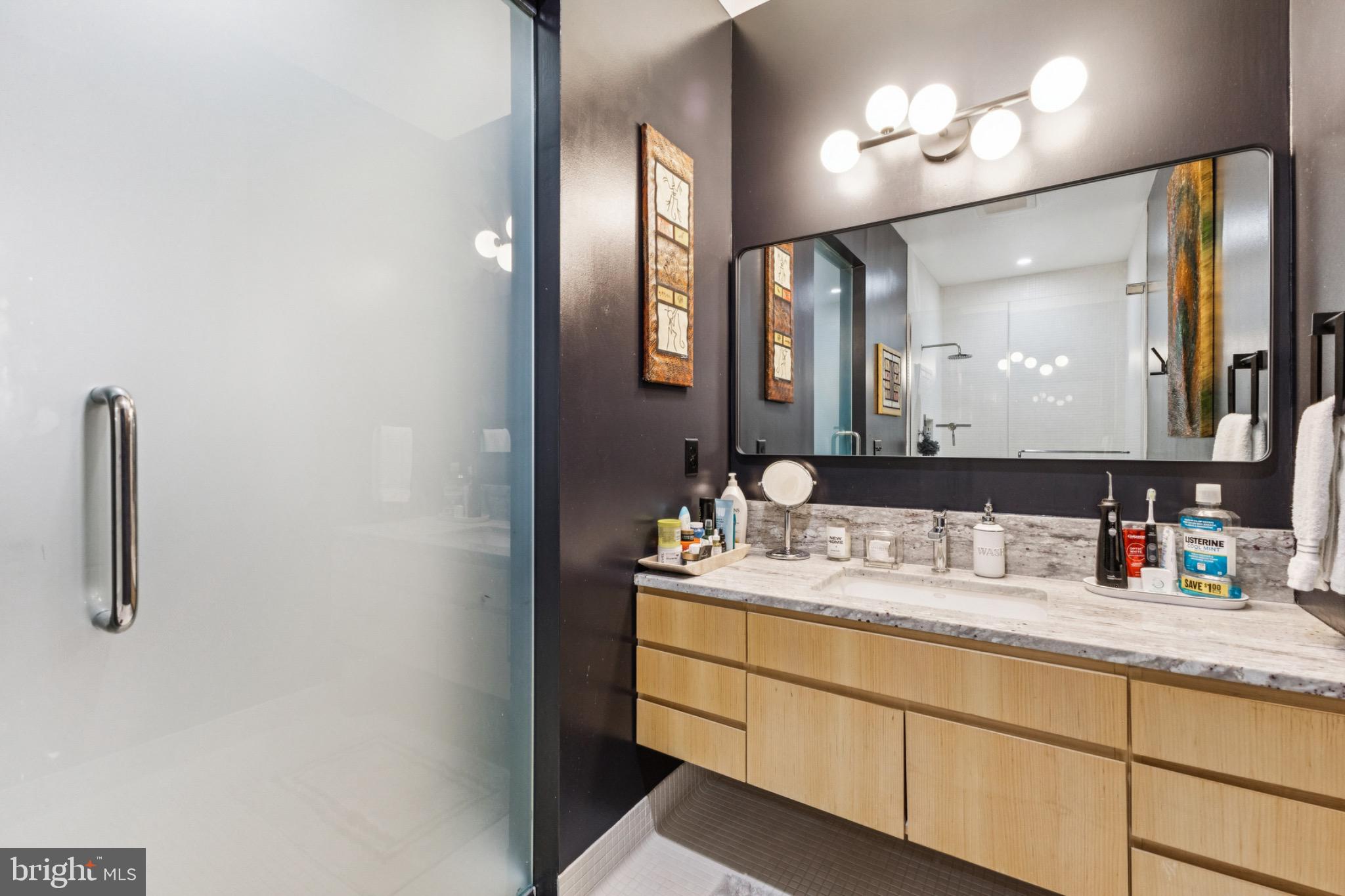 437 New York Avenue Northwest, Unit Y26 Washington, DC 20001 - Photo 12 of 16 a bathroom with a double vanity sink and a mirror