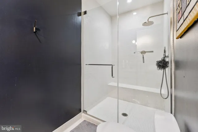 a bathroom with a glass shower door