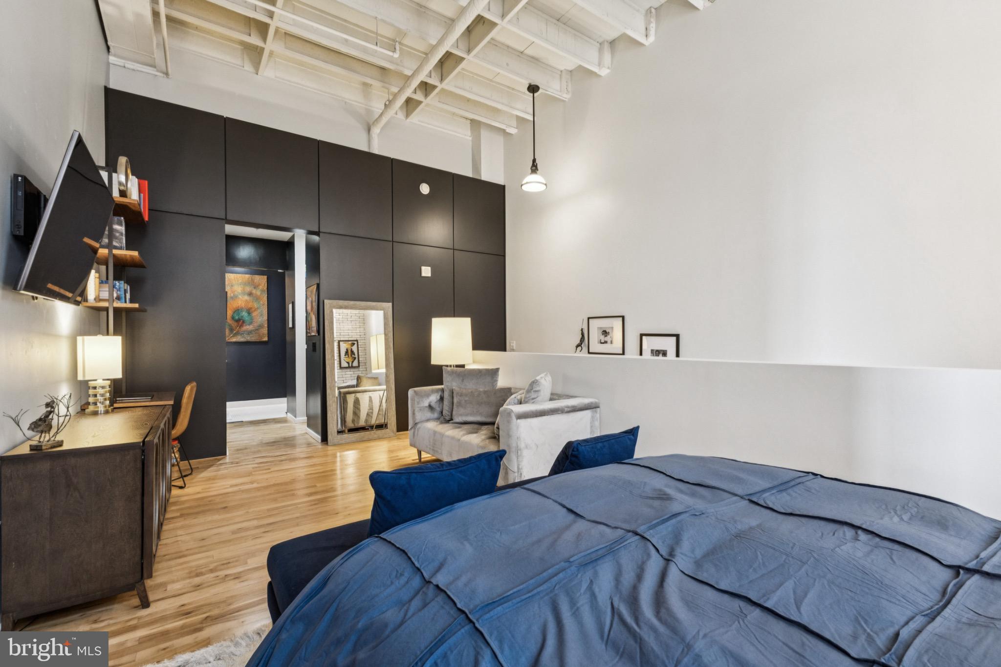 437 New York Avenue Northwest, Unit Y26 Washington, DC 20001 - Photo 9 of 16 a bed room with a bed and cabinets