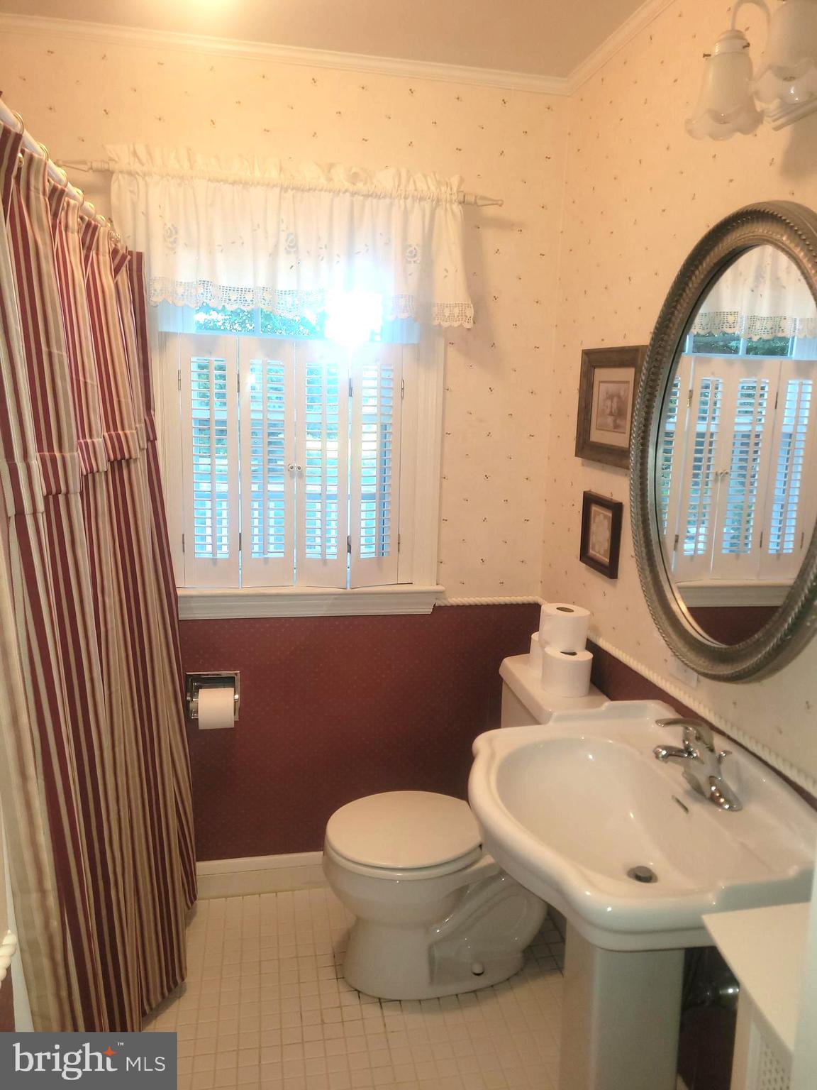 715 Sullivan Road Westminster, MD 21157 - Photo 24 of 59 a bathroom with a sink a mirror and a toilet