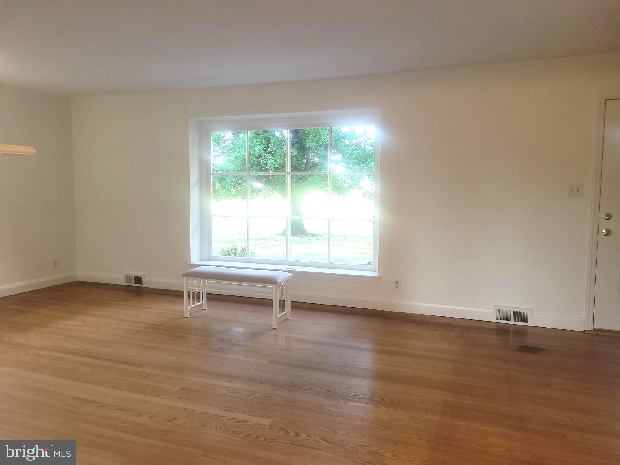 715 Sullivan Road Westminster, MD 21157 - Photo 3 of 59 an empty room with wooden floor and windows