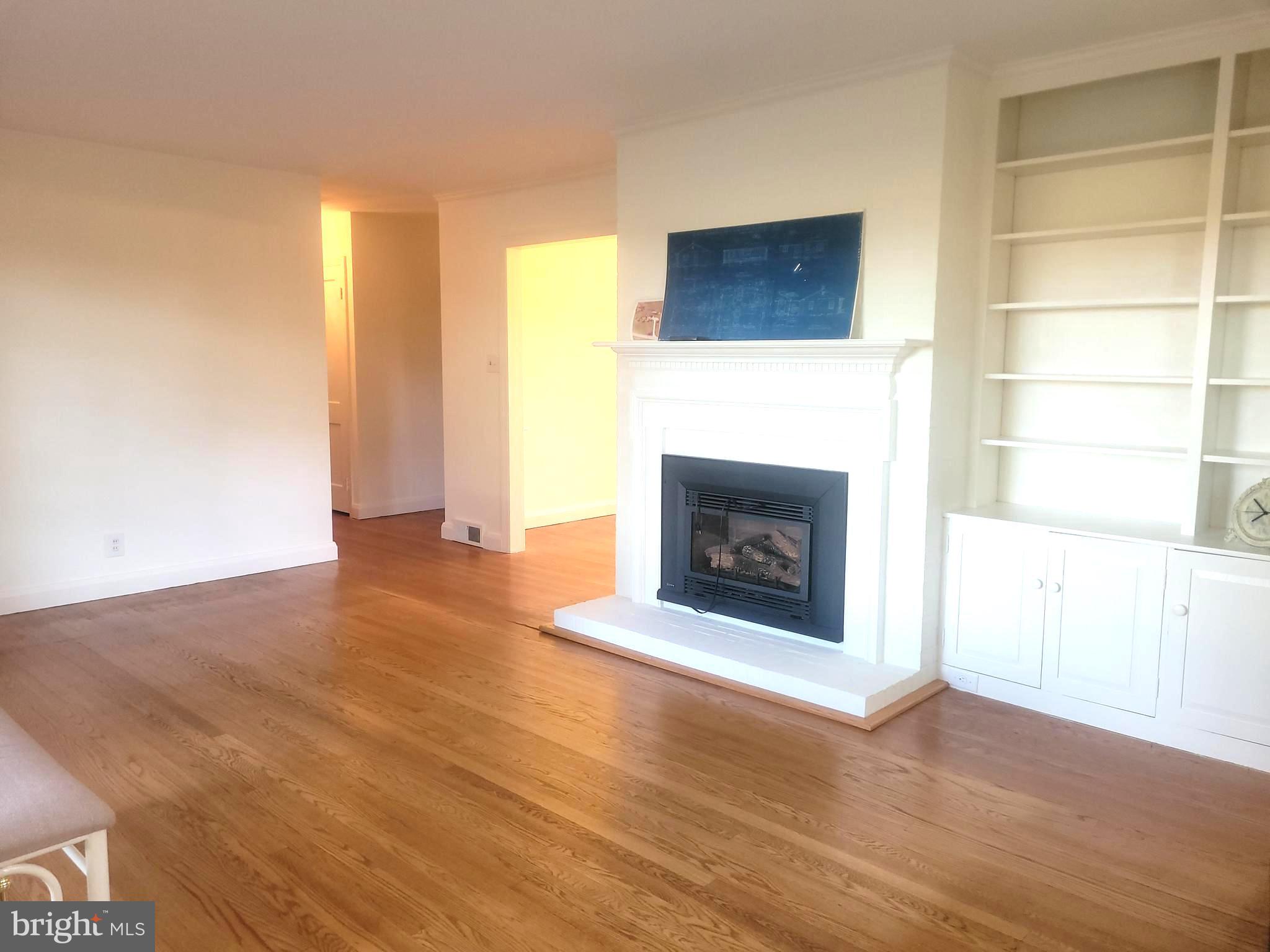 715 Sullivan Road Westminster, MD 21157 - Photo 31 of 59 a view of an empty room with wooden floor and a fireplace