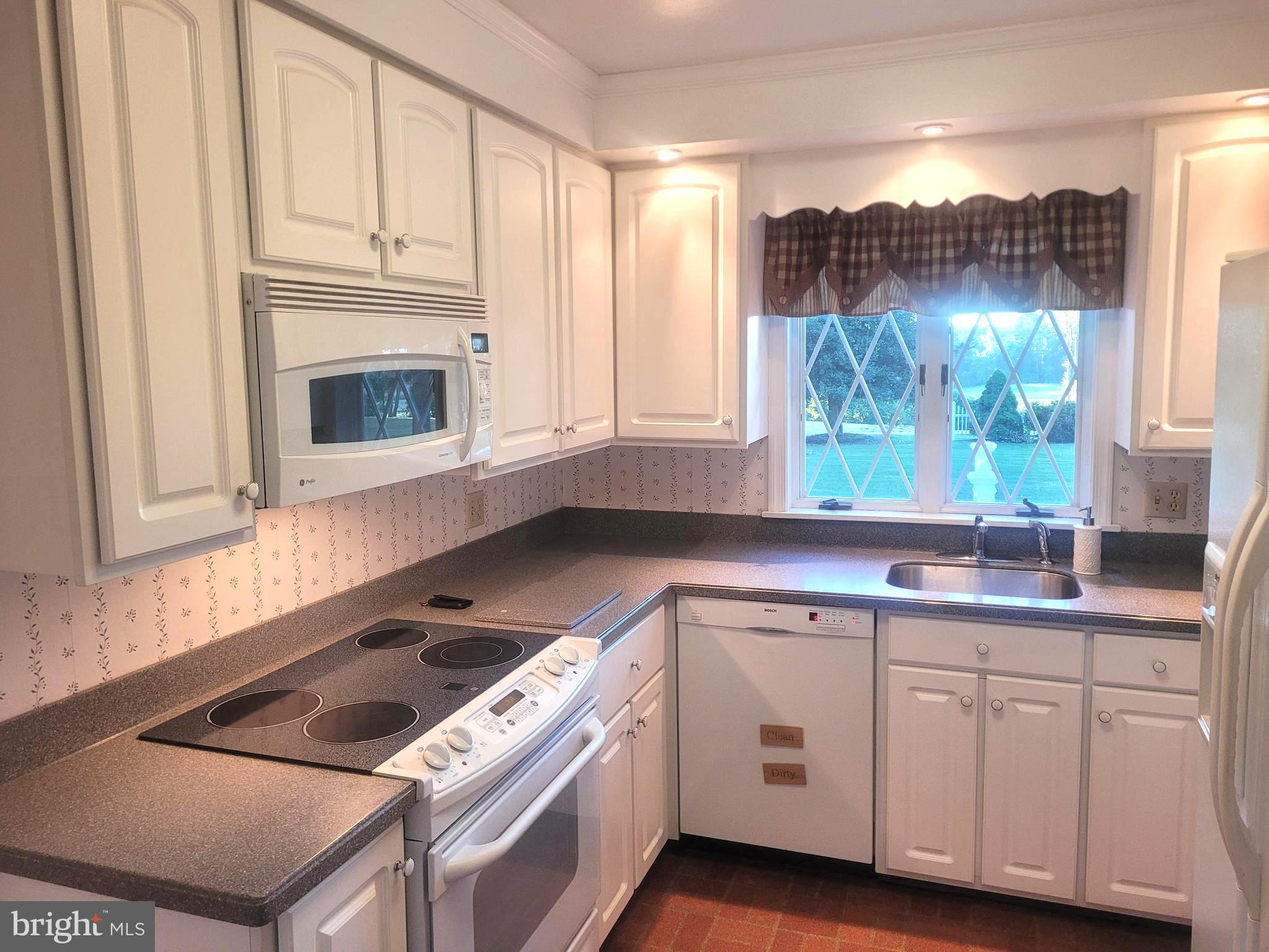 715 Sullivan Road Westminster, MD 21157 - Photo 5 of 59 a kitchen with cabinets appliances a sink and a window
