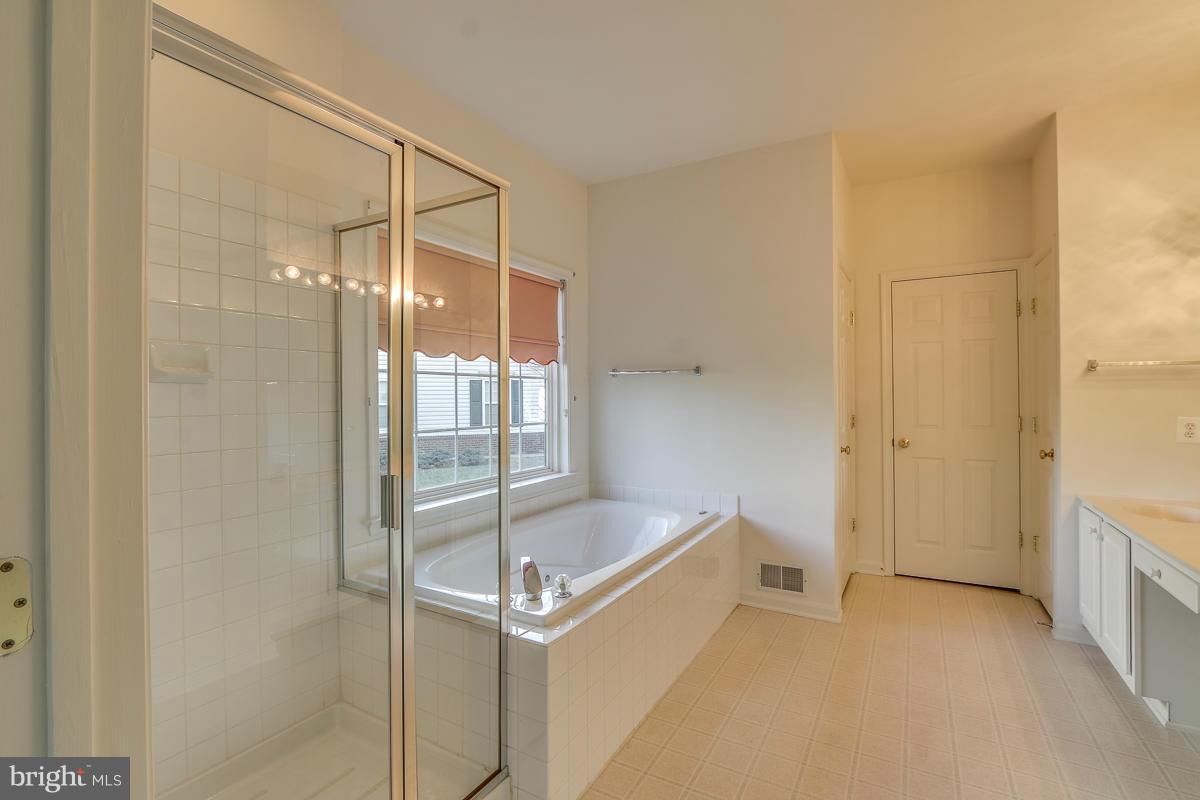 2482 Leyland Ridge Road Herndon, VA 20171 - Photo 15 of 29 a bathroom with a tub and shower