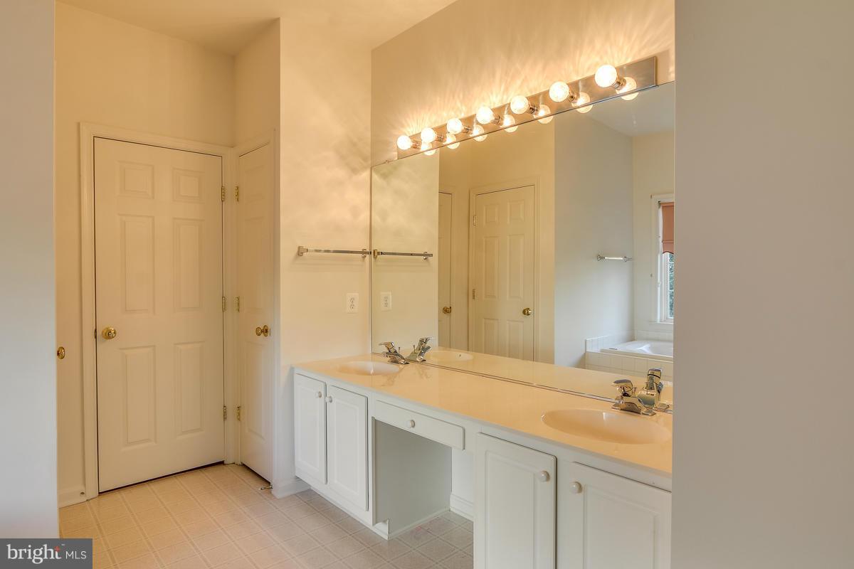2482 Leyland Ridge Road Herndon, VA 20171 - Photo 16 of 29 a bathroom with a double vanity sink and a mirror