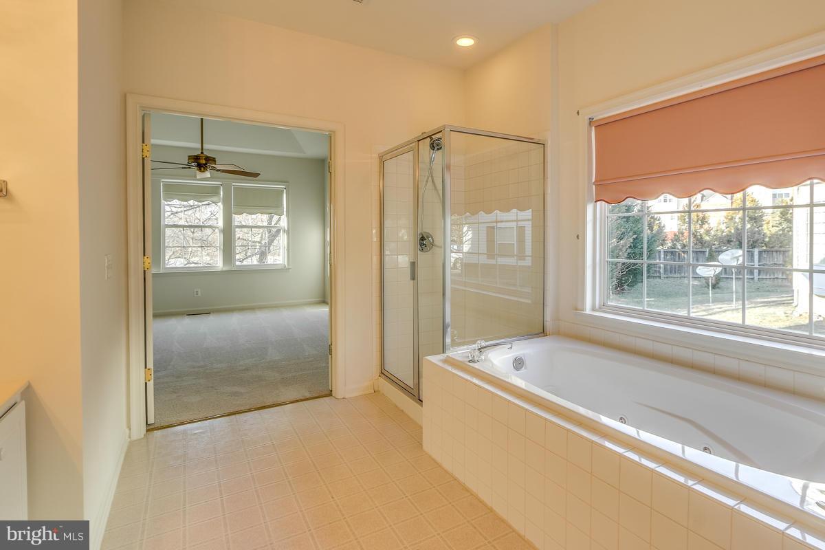 2482 Leyland Ridge Road Herndon, VA 20171 - Photo 18 of 29 a bathroom with a tub shower and sink