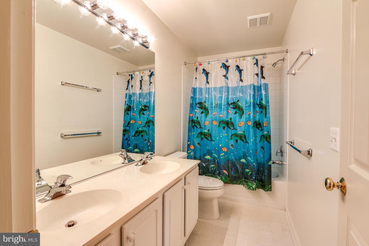 2482 Leyland Ridge Road Herndon, VA 20171 - Photo 21 of 29 a bathroom with a granite countertop sink a toilet and shower