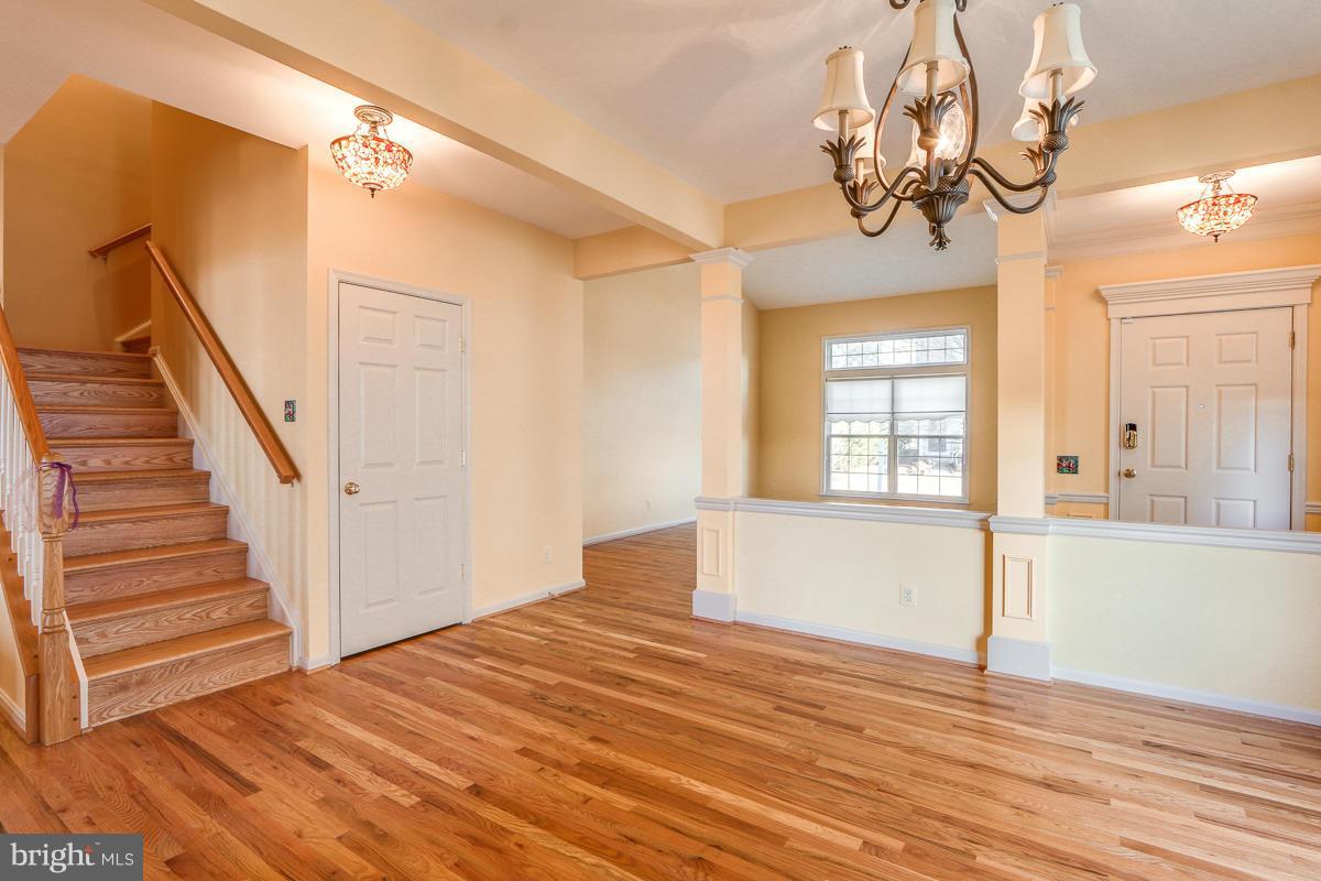 2482 Leyland Ridge Road Herndon, VA 20171 - Photo 7 of 29 a view of a livingroom with wooden floor and stairs