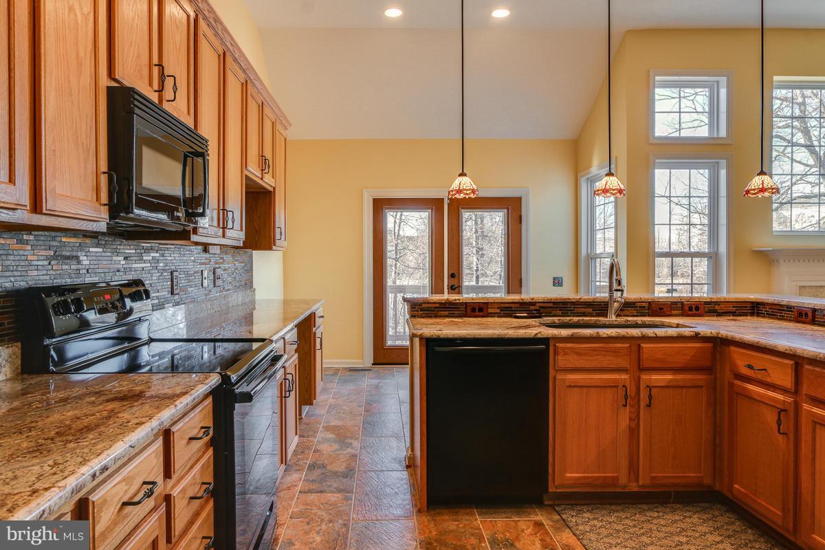 2482 Leyland Ridge Road Herndon, VA 20171 - Photo 8 of 29 a kitchen with stainless steel appliances granite countertop a stove a sink and a microwave