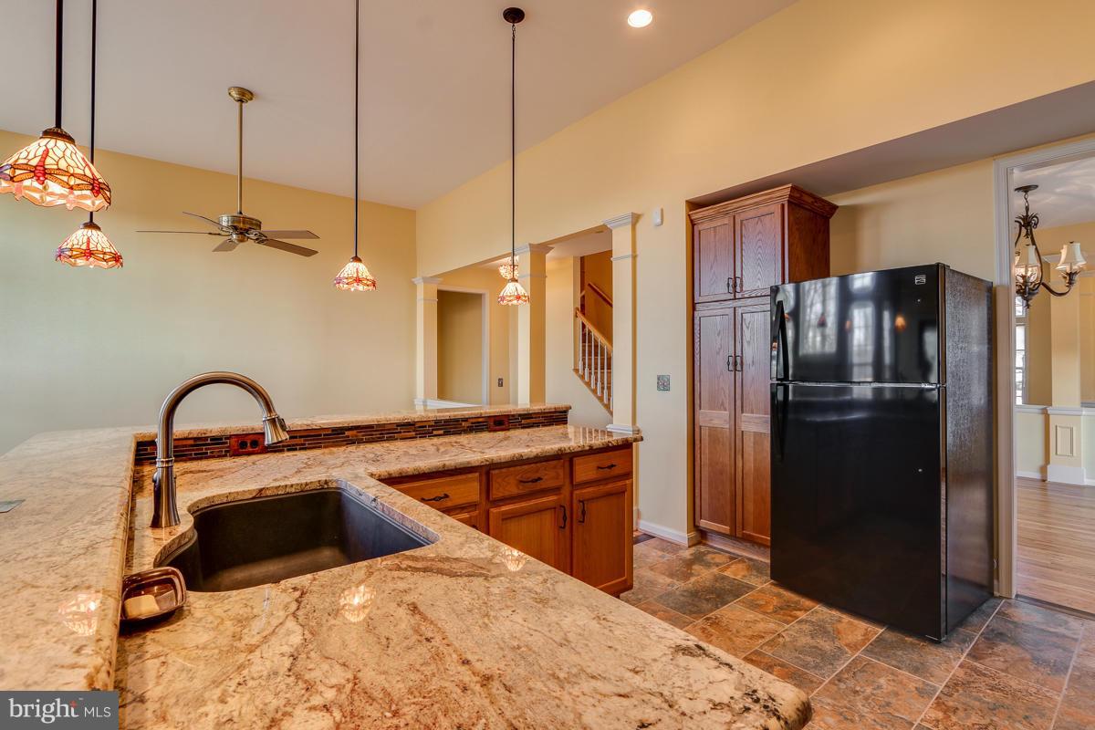 2482 Leyland Ridge Road Herndon, VA 20171 - Photo 9 of 29 a kitchen with stainless steel appliances kitchen island a refrigerator sink and stove