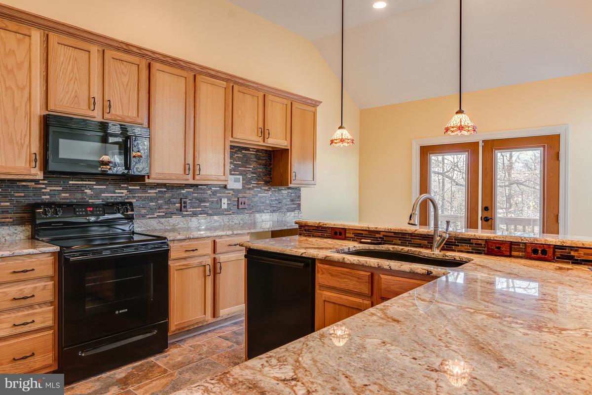 2482 Leyland Ridge Road Herndon, VA 20171 - Photo 10 of 29 a kitchen with stainless steel appliances granite countertop a stove a sink and a microwave